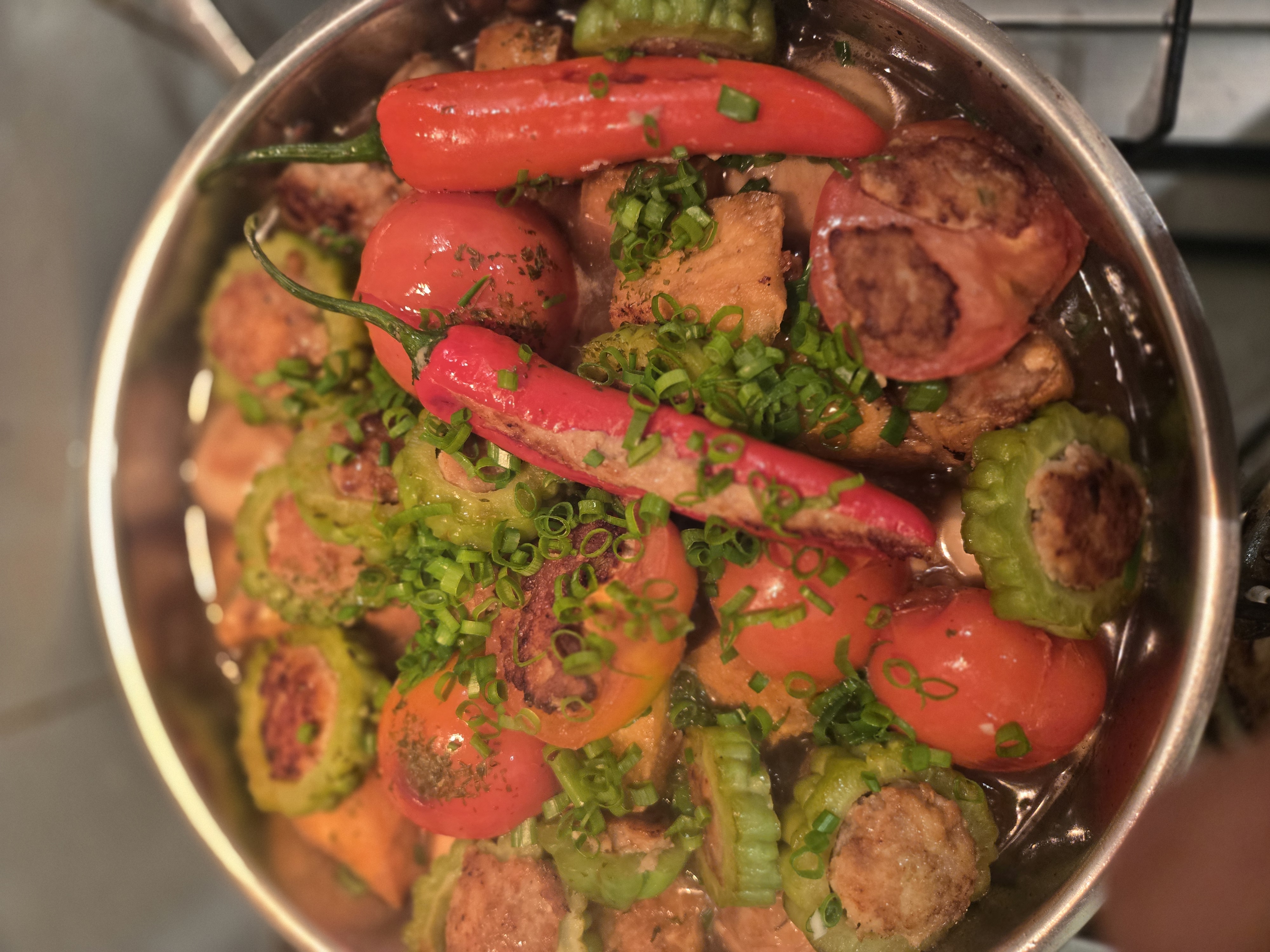 Stuffed yong tau foo pieces — chillies, bitter gourd rings, tomatoes — packed with pork-and-fish paste